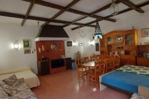 a living room with a bed and a dining room at Finca David Galdar in Las Palmas de Gran Canaria