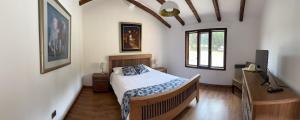 a bedroom with a bed and a television in it at El Tambo Retreat in Machachi