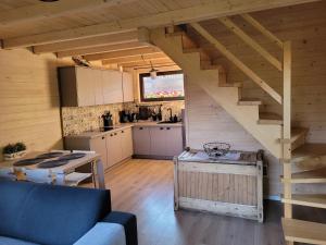 a kitchen and living room with a staircase in a cabin at Widokówka in Zawoja