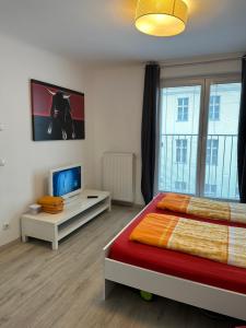 a bedroom with a bed and a flat screen tv at Apartment opera in Vienna