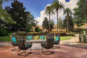 a table and chairs on a brick patio at Orlando Marriott Lake Mary in Lake Mary