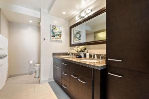 a bathroom with a sink and a mirror at Allure Waikiki condo in Honolulu
