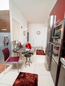 a kitchen and living room with a stainless steel refrigerator at Comfy and Cosy Studio Kalamata in Kalamata