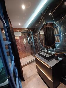 a bathroom with a shower with a sink and a mirror at apartament centrum-rynek Gorzów in Gorzów Wielkopolski