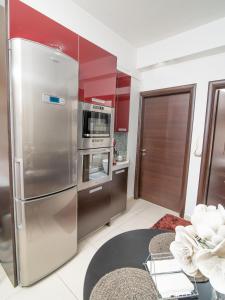 a kitchen with a large stainless steel refrigerator at Comfy and Cosy Studio Kalamata in Kalamata