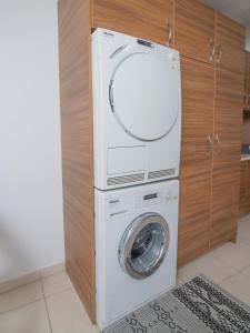 a washer and dryer in a kitchen next to a cabinet at Comfy and Cosy Studio Kalamata in Kalamata