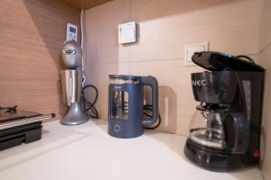 a kitchen counter with a coffee maker and a blender at Comfy and Cosy Studio Kalamata B in Kalamata