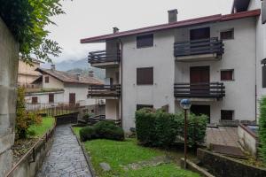 an apartment building with balconies and a courtyard at [IHost Flat] - Valmalenco Marconi 33 in Chiesa in Valmalenco