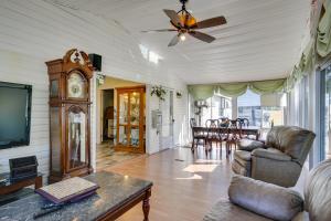a living room with a couch and a tv and a table at Spacious South Carolina Abode with Hot Tub and Grill! in Columbia