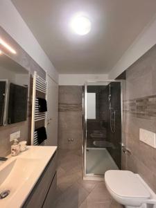 a bathroom with a shower and a toilet and a sink at VENEZIA Beach in Chioggia +19 photos