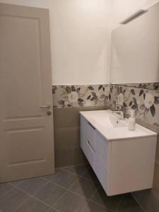 a bathroom with a white sink and a mirror at Casa dei Marinai a Pegli (Citra: 010025-LT-4074) in Genova