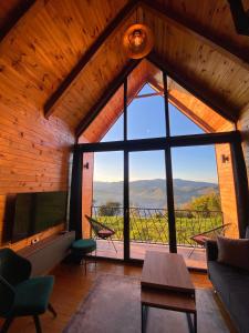a living room with a large window and a view at Woodhouse in Bijelo Polje