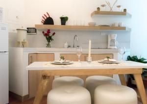 a kitchen with a table with two glasses of wine at Cozy Apartment I in Guatemala