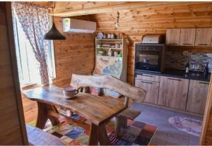 a wooden kitchen with a wooden table and a refrigerator at Holiday Home Jakov in Kolašin