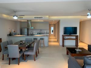 a kitchen and living room with a table and chairs at Peninsula 12 D in Ixtapa