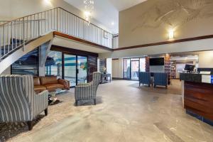 a living room with a staircase and a couch and chairs at Best Western PLUS City Centre Inn in Edmonton