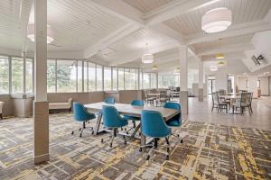 a large room with a table and chairs and windows at Quality Inn Idaho Falls in Idaho Falls