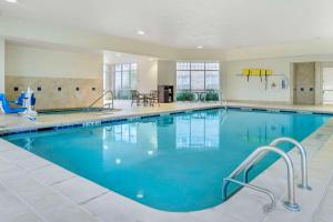 a large pool with blue water in a hotel room at Comfort Inn in Plainwell