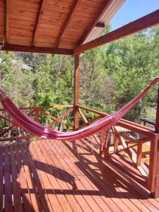 a hammock on the deck of a cabin at Cabañas Sidharta in Tigre
