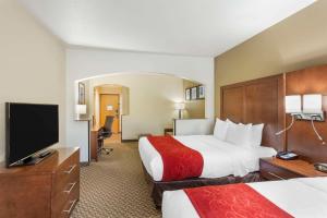 a hotel room with two beds and a flat screen tv at Comfort Suites Ogden Conference Center in Ogden