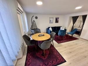 a living room with a table and chairs and a couch at Apartment EASY HOME in Sarajevo