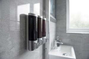 a bathroom with a soap dispenser on the wall at Mowbray Quarters of Cambridge in Cambridge +41 photos