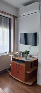 a room with a table with a tv on the wall at Divčibare Snežna Kraljica ap 13 in Divčibare