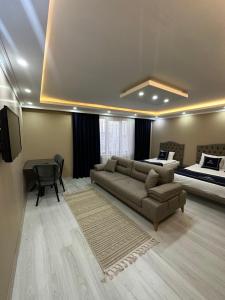 a living room with a couch and a bed at Loft House in Arnavutköy