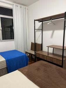 a room with a bed and a bed and a window at Apartamento 2 quartos Copacabana in Rio de Janeiro