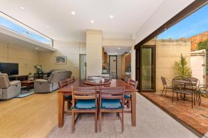a dining room and living room with a table and chairs at King Charming Cottage - Walk to the River in Fremantle