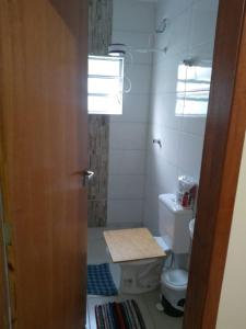 a bathroom with a toilet and a window at casa na praia Itanhaém in Guarulhos