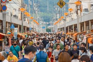 a crowd of people walking down a busy street at HOSTEL OE in Yoshinogawa