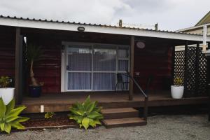 a porch of a house with a sliding glass door at Rustic Rails Accommodation in Dargaville