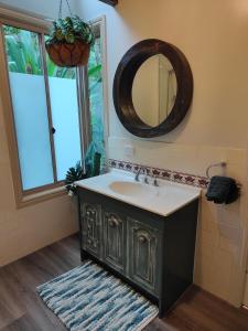 a bathroom with a sink and a mirror at Springbrook Storybook in Springbrook