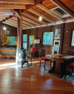 a living room with a table and a bedroom at Springbrook Storybook in Springbrook