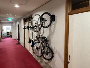 a bike hanging on a wall in a hallway at HOSTEL OE in Yoshinogawa