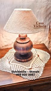 a lamp sitting on top of a table at Casa Victoria, habitaciones y zona de camping in Otavalo