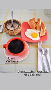 a table with a cup of coffee and eggs and toast at Casa Victoria, habitaciones y zona de camping in Otavalo