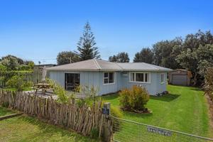 a house in a yard with a fence at Sandbach - Ohiwa Harbour in Waiotahi