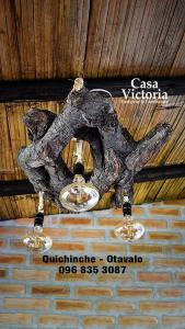 a chandelier hanging from the ceiling of a building at Casa Victoria, habitaciones y zona de camping in Otavalo
