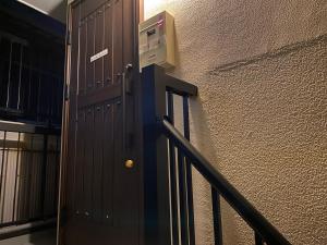 a door leading up to a staircase with a wall and a door at Numazu Ikyuuan 沼津一休庵 in Numazu