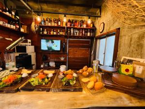 a kitchen with several plates of food on a table at HOSTEL OE in Yoshinogawa