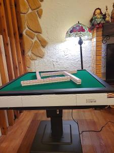 a ping pong table with a cue ball on it at British Country Inn B&B in Luodong