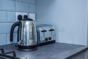 a tea kettle sitting on a counter in a kitchen at Lush Lodge -Home away in Telford in Telford