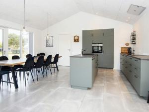 a kitchen and dining room with a table and chairs at 9 person holiday home in Glesborg-By Traum in Glesborg