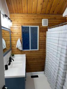 a bathroom with a sink and a window and a shower at Charming Nordic Style - 2BR + 1 Bath Entire House in Sudbury
