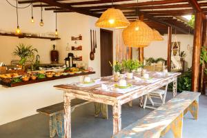 a dining room with a table and benches in a room at VILA TRANCOSEAR in Trancoso
