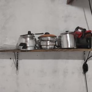 a shelf with pots and pans on it at João de Barro Hospedagem in Caeté-Açu +35 photos