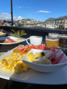 a plate of breakfast food on a table at Hostal La Guayunga RoofTop in Quito