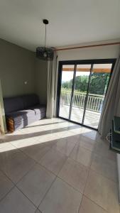 a living room with a large sliding glass door at La Kay Jade in Saint-Pierre